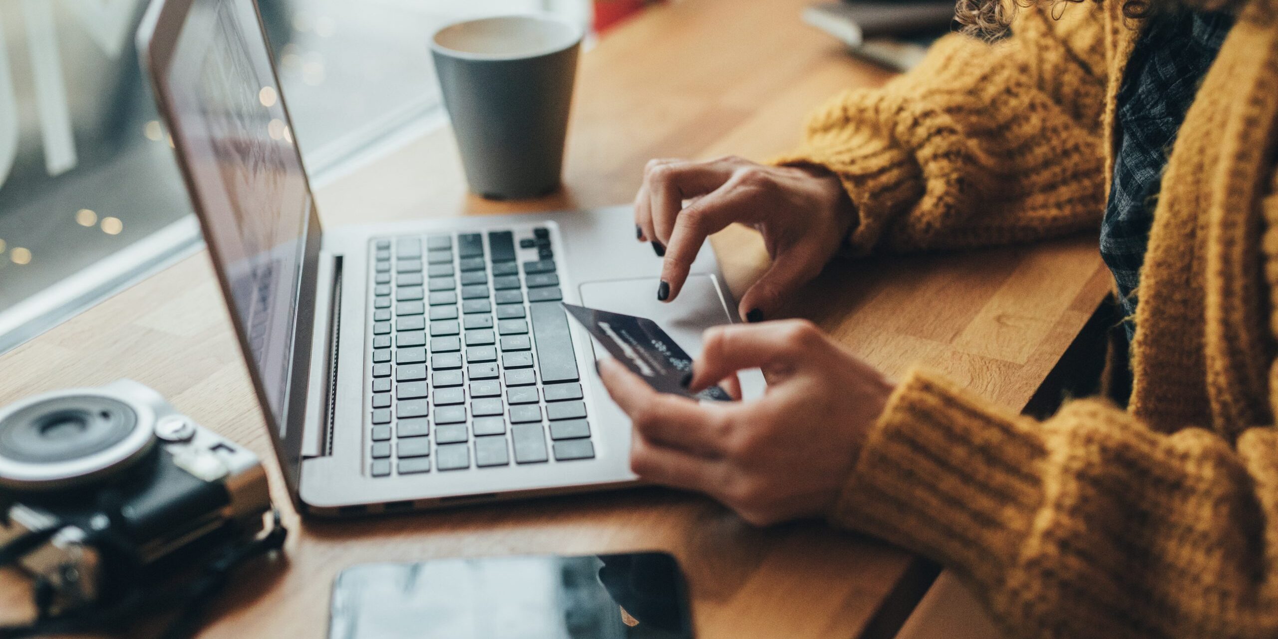 Woman in cafe shopping online with laptop